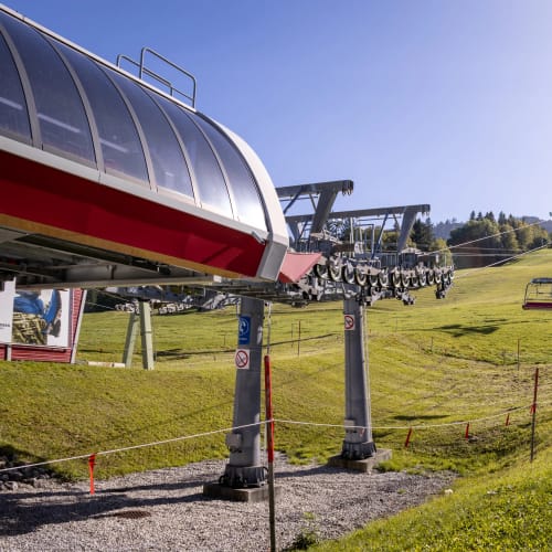 Skilift am Hang mit Sessellift und Grüngelände bei sonnigem Himmel